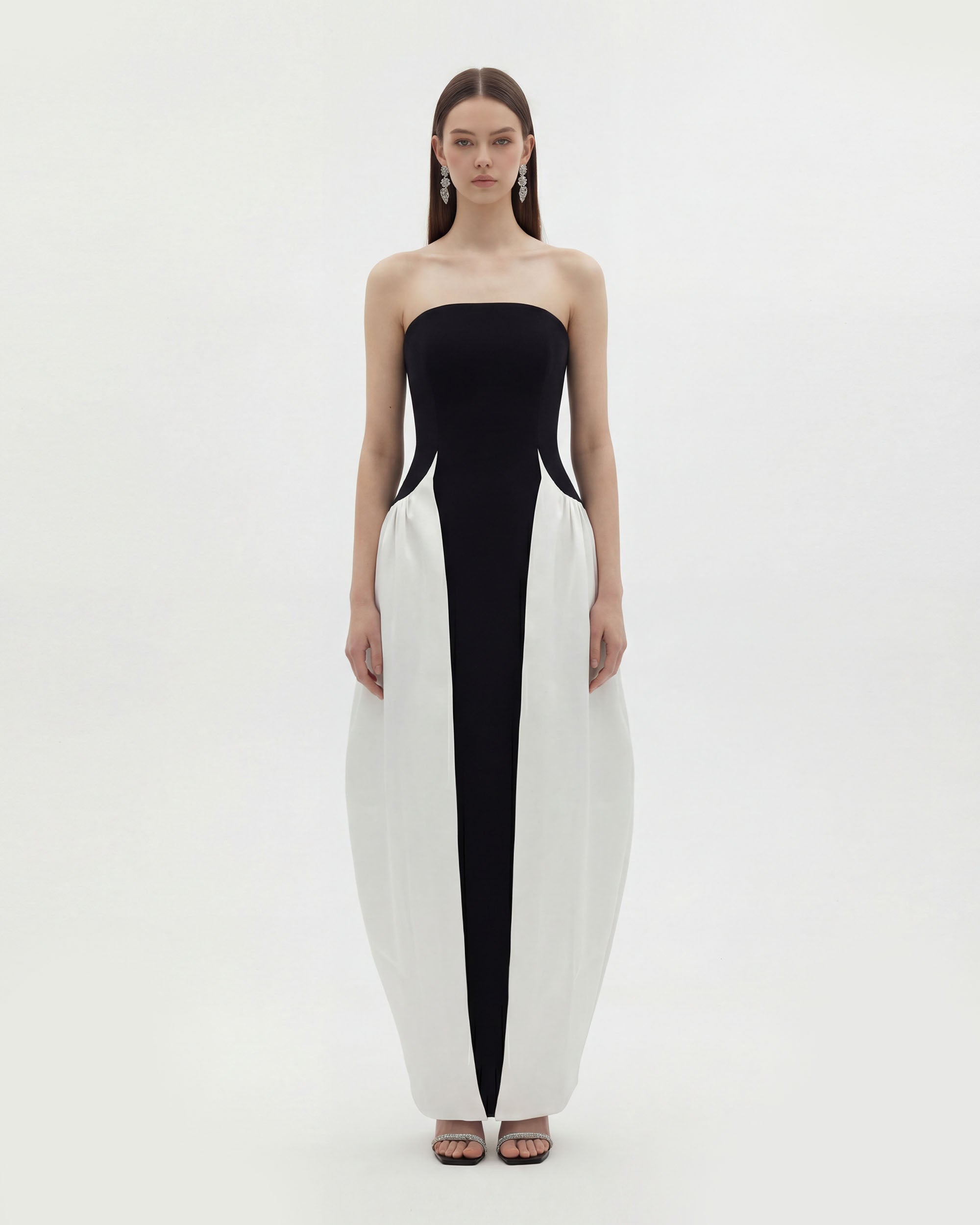 Front view of the black sculptural strapless maxi dress